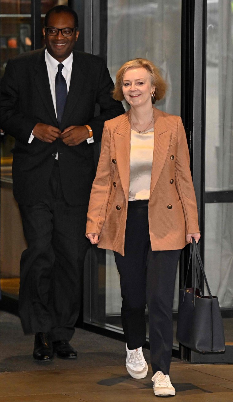 Britain's Prime Minister Liz Truss leaves her hotel for a second time, with Britain's Chancellor of the Exchequer Kwasi Kwarteng, on the third day of the annual Conservative Party Conference in Birmingham, central England, on October 4, 2022. (Photo by Oli SCARFF / AFP) (Photo by OLI SCARFF/AFP via Getty Images)