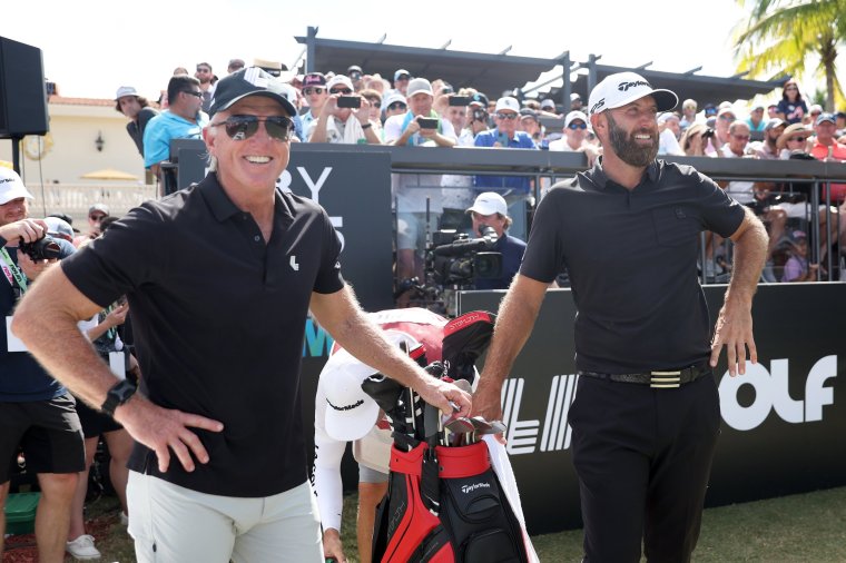 DORAL, FLORIDA - OCTOBER 30: Greg Norman, CEO and commissioner of LIV Golf, and Team Captain Dustin Johnson of 4 Aces GC wait on the first tee during the team championship stroke-play round of the LIV Golf Invitational - Miami at Trump National Doral Miami on October 30, 2022 in Doral, Florida. (Photo by Jonathan Ferrey/LIV Golf via Getty Images)