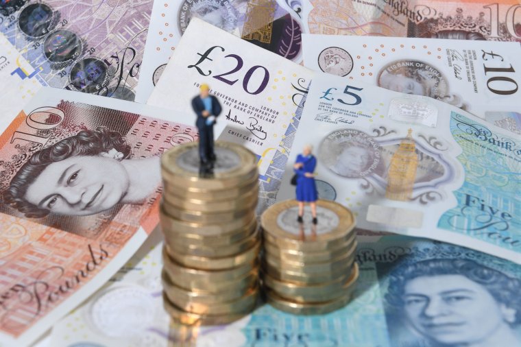 File photo dated 11/09/18 of models of a man and woman standing on a pile of coins and bank notes. Options to help workers to achieve better retirement outcomes, including those with several small pension pots scattered around, are being looked into by the Government. With the average worker having around 11 jobs over the course of their career, some may end up with multiple small pension pots. Issue date: Monday January 30, 2023. PA Photo. See PA story MONEY Pension. Photo credit should read: Joe Giddens/PA Wire