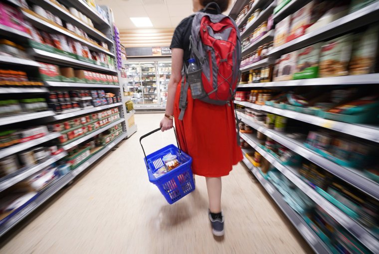 EMBARGOED TO 0800 TUESDAY MAY 23 File photo dated 03/09/22 of a shopper walking through the aisle of a Tesco supermarket, as the grocery price inflation has fallen for the second month in a row, but is still adding an extra ?833 to the average consumer's annual bill, according to latest figures. Prices over the four weeks to May 14 were 17.2% higher than a year ago, down from April's 17.3%, Kantar said. Issue date: Tuesday May 23, 2023. PA Photo. See PA story CONSUMER Groceries. Photo credit should read: Yui Mok/PA Wire