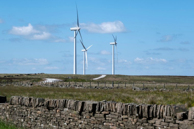 Wind turbines behind a dry stone wall on Ovenden Moor in West Yorkshire on 5th June 2023 in Ogden near Halifax, United Kingdom. Ovenden Moor Wind Farm is a wind powered electricity generating site located north of Halifax in West Yorkshire which was opened in 1993 with 23 turbines. They have been subject of continued criticism and objections. (photo by Mike Kemp/In Pictures via Getty Images)