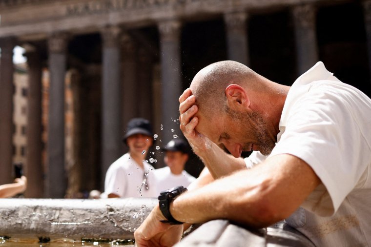 FILE PHOTO: Roberto Klarich from Canada cools off at a fountain near the Pantheon, after giving up queuing to enter because it is too hot and the queue is too long, during a heatwave across Italy as temperatures are expected to cool off in the Italian capital, in Rome, Italy July 19, 2023. REUTERS/Guglielmo Mangiapane/File Photo