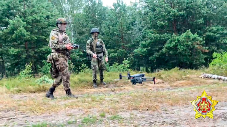 In this photo taken from video and released by Belarus' Defense Ministry on Thursday, July 20, 2023, A Belarusian soldier of the Special Operations Forces (SOF) and a mercenary fighter from Wagner private military company use a drone during the weeklong maneuvers that will be conducted at a firing range near the border city of Brest, Belarus. Mercenaries from Russia's military company Wagner have launched joint drills with the Belarusian military near the border with Poland following their relocation to Belarus after their short-lived rebellion. (Belarus' Defense Ministry via AP)