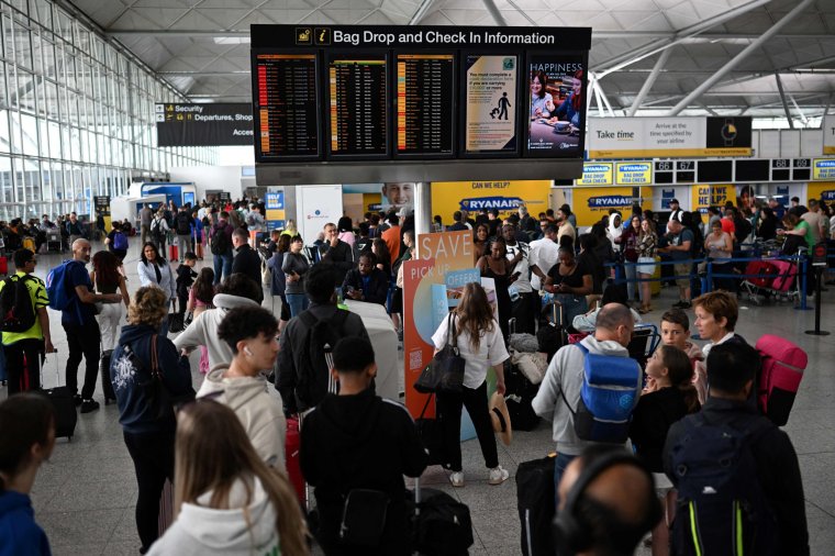 Passengers wait at London Stansted after UK flights were delayed. Flights to and from the UK were experiencing disruptions after Britain's air traffic control systems were temporarily hit by a technical fault. The National Air Traffic Services (NATS) said it had "identified and remedied" a technical issue which forced it to impose traffic flow restrictions. (Photo by Daniel LEAL / AFP) (Photo by DANIEL LEAL/AFP via Getty Images)