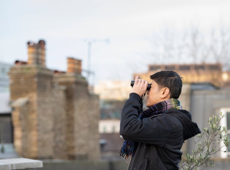 Ravin and Torben on their roof terrace taking part in the RSPB's annual Big Garden Birdwatch activity, Waterloo, London, Winter 2023 Images from RSPB via Helen Moffat (Helen.Moffat@rspb.org.uk)