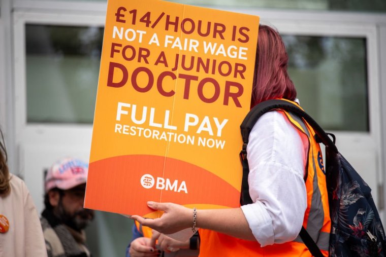 LONDON, UNITED KINGDOM - 2023/08/11: A protester holds a placard expressing her opinion during the demonstration outside of the University College Hospital. Junior doctors started their fifth round of the 96-hour strike outside of the University College Hospital. The British Medical Association demands full pay restoration for junior doctors because their payment has been cut off by more than a quarter since 2008. (Photo by Krisztian Elek/SOPA Images/LightRocket via Getty Images)