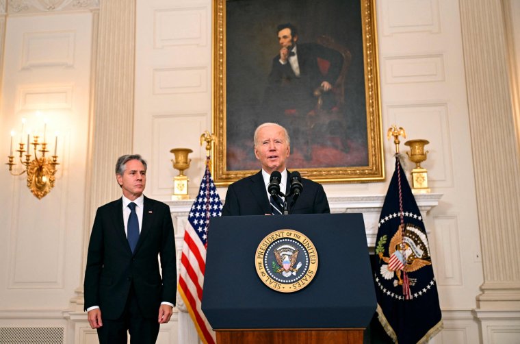 US President Joe Biden, with Secretary of State Antony Blinken, addresses the attacks in Israel from the State Dining Room of the White House in Washington, DC, on October 7, 2023. Palestinian militant group Hamas launched a surprise large-scale attack against Israel Saturday, firing thousands of rockets from Gaza and sending fighters to kill or abduct people as Israel retaliated with devastating air strikes. (Photo by Jim WATSON / AFP) (Photo by JIM WATSON/AFP via Getty Images)