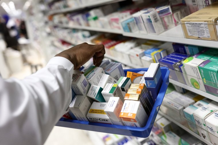 FILE: A pharmacist collects packets of boxed medication from the shelves of a pharmacy in London, U.K., on Monday, Dec. 14, 2015. As the U.K. government proposes spending 160 million pounds ($207 million) to support medical research and health care we select our best archive images on health. Photographer: Simon Dawson/Bloomberg via Getty Images