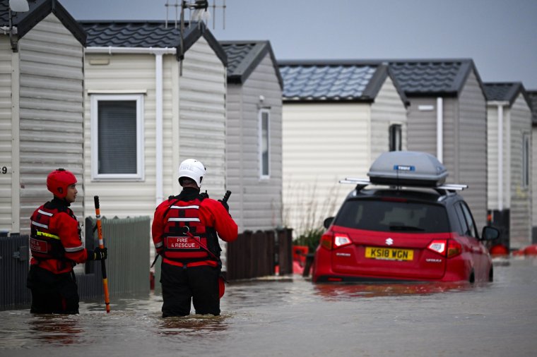 BURTON BRADSTOCK, DORSET - NOVEMBER 02: Fire and rescue officers search for people in need of rescue from their holiday chalets at Freshwater Beach Holiday Park, on November 02, 2023 in Burton Bradstock, Dorset. Storm Ciaran swept across the southwest and south of England overnight posing a formidable threat in certain areas such as Jersey, where winds exceeded 100 mph overnight. This, along with the already-soaked ground from Storm Babet, increases the risk of flooding in already vulnerable areas. (Photo by Finnbarr Webster/Getty Images)