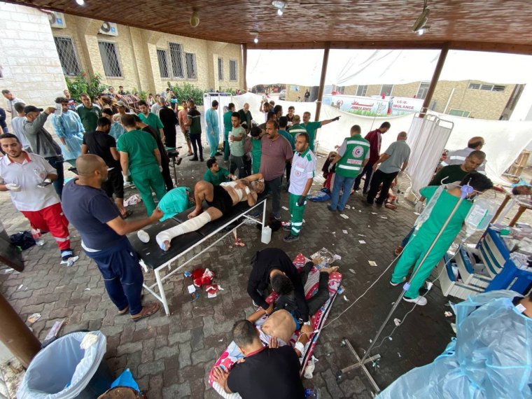 GAZA CITY, GAZA - NOVEMBER 14: (EDITORS NOTE: Image depicts graphic content) Injured Palestinians receive medical treatment at the yard of the Al-Ahli Baptist Hospital after Israel's airstrikes as Israeli army's strikes continue on its 39th day in Gaza Strip on November 14, 2023. (Photo by Montaser Alsawaf/Anadolu via Getty Images)