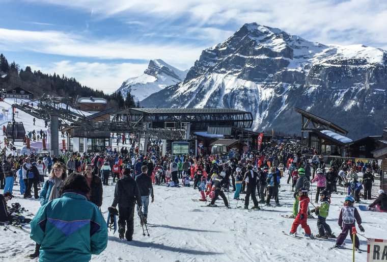 People queue to take a ski lift, on February 23, 2017 at "Les Carroz d'Araches" ski resort. / AFP PHOTO / DENIS CHARLET (Photo credit should read DENIS CHARLET/AFP via Getty Images)