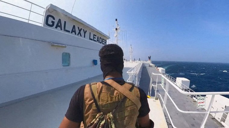 FILE PHOTO: A Houthi fighter stands on the Galaxy Leader cargo ship in the Red Sea in this photo released November 20, 2023. Houthi Military Media/Handout via REUTERS THIS IMAGE HAS BEEN SUPPLIED BY A THIRD PARTY/File Photo