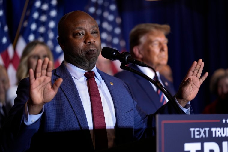 Republican presidential candidate former President Donald Trump listens as Sen. Tim Scott, R-S.C., speaks at a primary election night party in Nashua, N.H., Tuesday, Jan. 23, 2024. (AP Photo/Matt Rourke)