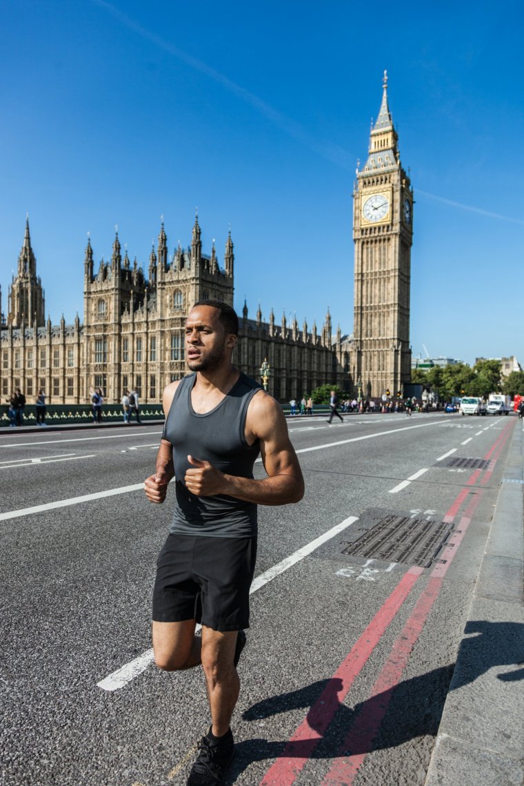 One healthy man running in Central London in the early morning.