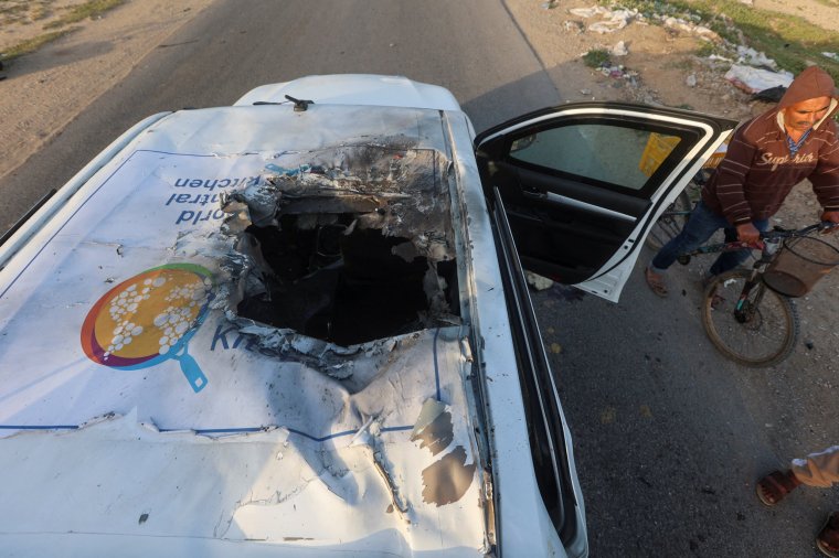 A Palestinian man rides a bicycle past a damaged vehicle where employees from the World Central Kitchen (WCK), including foreigners, were killed in an Israeli airstrike, according to the NGO as the Israeli military said it was conducting a thorough review at the highest levels to understand the circumstances of this "tragic" incident, amid the ongoing conflict between Israel and Hamas, in Deir Al-Balah, in the central Gaza, Strip April 2, 2024. REUTERS/Ahmed Zakot