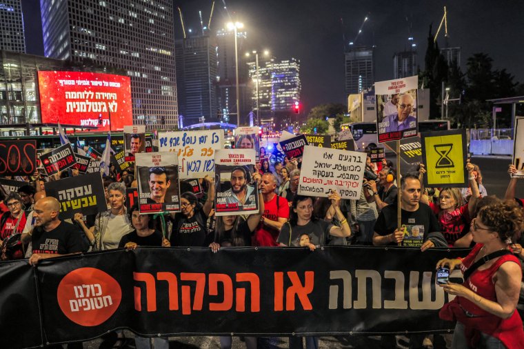 Protesters block traffic along a road during a demonstration by the relatives of hostages hostages taken captive by Palestinian militants in the Gaza Strip during the October 7 attacks, and supporters, demanding action to set them free outside the Kirya base which houses the Israeli defence ministry headquarters in Tel Aviv on April 18, 2024 amid the ongoing conflict in the Palestinian territory between Israel and the militant group Hamas. (Photo by AHMAD GHARABLI / AFP) (Photo by AHMAD GHARABLI/AFP via Getty Images)