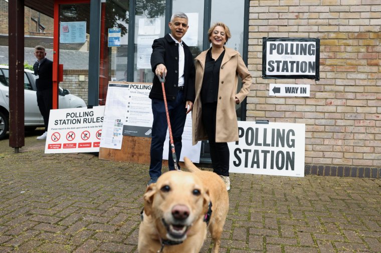 Mayor of London Sadiq Khan and his wife Saadiya react standing with their dog Luna outside a polling station during local elections in London, Britain May 2, 2024. REUTERS/Hollie Adams