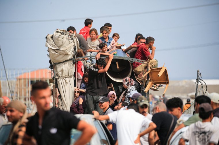 Palestinians flee the area of Tal al-Sultan in Rafah with their belongings following renewed Israeli strikes in the city in the southern Gaza Strip on May 28, 2024, amid the ongoing conflict between Israel and the Palestinian Hamas militant group. (Photo by Eyad BABA / AFP) (Photo by EYAD BABA/AFP via Getty Images)