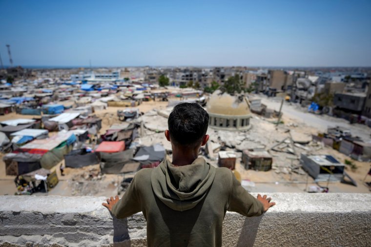 Mahmoud Rayhan, who was displaced by the Israeli bombardment of the Gaza Strip, stands at a makeshift tent camp in Khan Younis, Wednesday, June 26, 2024. Hundreds of thousands of Palestinians in Gaza are struggling to maintain their mental health with few resources and no safe places to recover after nine months of war. (AP Photo/Abdel Kareem Hana)