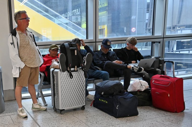 Passengers wait in the check-in area of Gatwick Airport as some flights are cancelled or delayed, in Horley, south of London on July 20, 2024. (Photo by Justin TALLIS / AFP) (Photo by JUSTIN TALLIS/AFP via Getty Images)