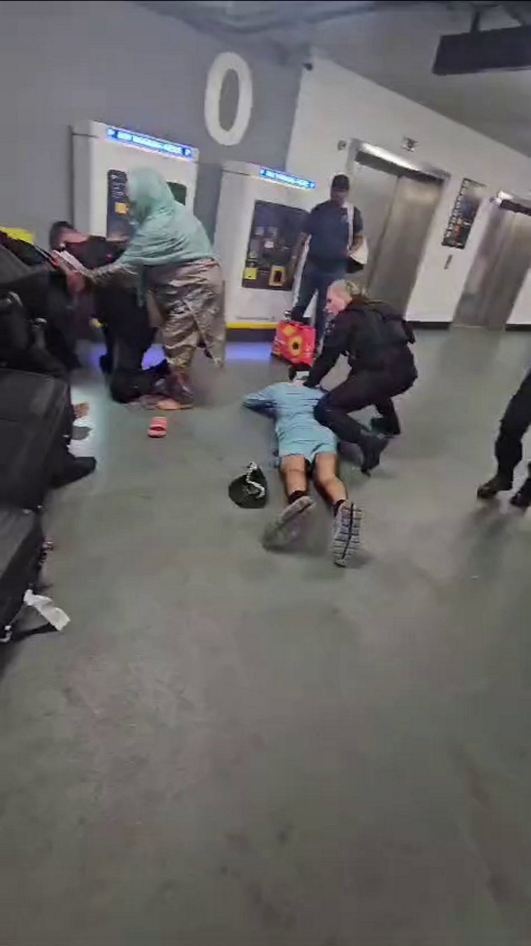 Policeman appears to stamp on mans head after tasering in violent scenes at Manchester Airport. Policeman appears to stamp on mans head after tasering in violent scenes. A GMP spokesperson said: ?Officers were called to reports of an altercation between members of the public in Terminal 2 at Manchester Airport. ?Whilst attempting to arrest one of the suspects of the earlier altercation, three officers were subject to a violent assault, where they were punched to the ground. A female officer suffered a broken nose and all three were taken to hospital for treatment. ?As the attending officers were firearms officers, there was a clear risk during this assault of their firearms being taken from them.