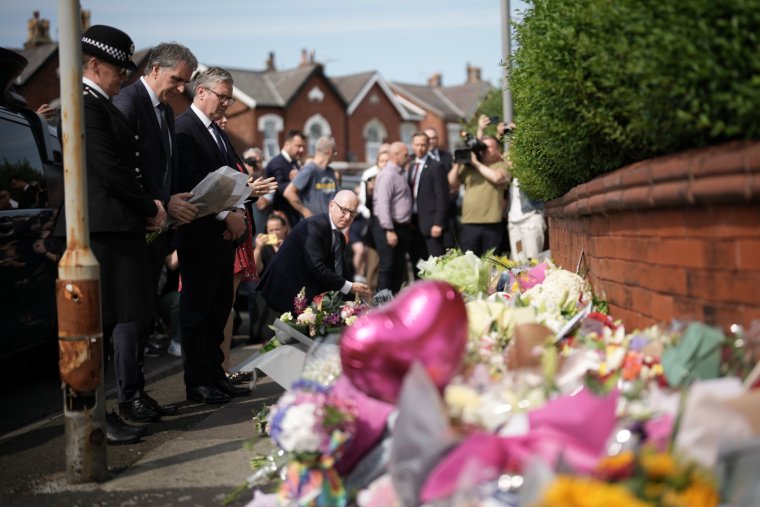 SOUTHPORT, ENGLAND - JULY 30: British Prime Minister Sir Keir Starmer leaves a floral tribute to the child victims of a knife attack on July 30, 2024 in Southport, England. A teenager armed with a knife attacked children at a Taylor Swift-themed holiday club in Hart Lane, Southport yesterday morning. Three children have died while five children and two adults remain in a critical condition in hospital. A 17-year-old boy has been arrested. (Photo by Christopher Furlong/Getty Images)