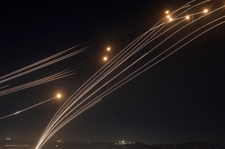 Rockets fired from southern Lebanon are intercepted by Israel's Iron Dome air defence system over the Upper Galilee region in northern Israel, on August 4, 2024, amid ongoing cross-border clashes between Israeli troops and Lebanon's Hezbollah fighters. Middle East tensions soared Saturday as Iran and its allies readied their response to the assassination of Hamas's political leader, blamed on Israel, spurring fears of a regional war. (Photo by Jalaa MAREY / AFP) / "The erroneous mention[s] appearing in the metadata of this photo by Jalaa MAREY has been modified in AFP systems in the following manner: [Druze men in the village of Ain al-Tineh] instead of [Druze elders in the Israeli-annexed Golan Heights village of Majdal Shams ]. Please immediately remove the erroneous mention[s] from all your online services and delete it (them) from your servers. If you have been authorized by AFP to distribute it (them) to third parties, please ensure that the same actions are carried out by them. Failure to promptly comply with these instructions will entail liability on your part for any continued or post notification usage. Therefore we thank you very much for all your attention and prompt action. We are sorry for the inconvenience this notification may cause and remain at your disposal for any further information you may require." (Photo by JALAA MAREY/AFP via Getty Images)