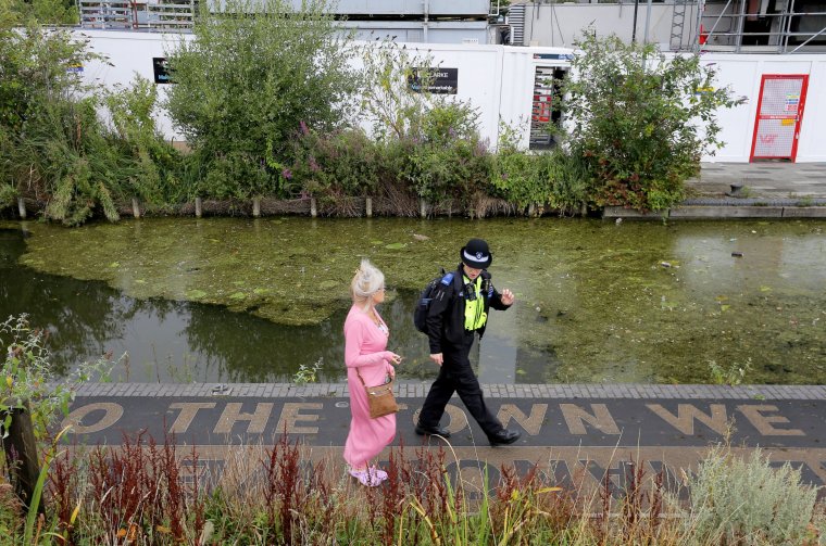 A PCSO talks to locals in Walsall town centre, West Midlands, where a cordon has been sent up next to the canal basin. August 14, 2024. Release date ? August 14, 2024. A major incident has been declared following a toxic chemical spillage in a West Midlands canal - with experts testing for deadly sodium cyanide. Residents are being told to stay away from a 14 mile stretch of waterways across Walsall, Birmingham and West Bromwich following the spill on Monday (12/8). The Environment Agency has been testing the canal for poisonous sodium cyanide and other dangerous chemicals in the affected area. Walsall Council warned there is a 'potential serious health risk' to people or animals who has had direct physical contact with the contaminated water. Public Health England says exposure to sodium cyanide, which can dissolve in water, in high enough concentrations can be fatal. Ingesting cyanide salts releases cyanide into the body and can cause headaches, nausea, dizziness, confusion, changes in heart rate and loss of consciousness.