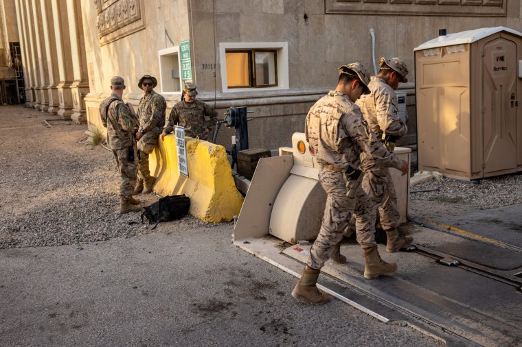 BAGHDAD, IRAQ - MAY 30: U.S. Army soldiers watch as fellow Coalition soldiers pass by near the entrance to the International Zone on May 30, 2021 in Baghdad, Iraq. Coalition forces based in Baghdad's International Zone are part of the U.S.-led Military Advisor Group of 13 nations supporting the Iraqi Security Forces. The United States currently maintains 2,500 military personnel in Iraq as part of Operation Inherent Resolve. (Photo by John Moore/Getty Images)