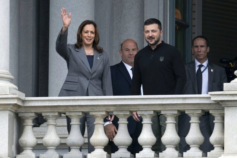 Vice President Kamala Harris accompanied by Ukraine's President Volodymyr Zelenskyy, waves to the media from the balcony of the Eisenhower Executive Office Building on the White House complex in Washington.Thursday, Sept. 26, 2024, (AP Photo/Jose Luis Magana)