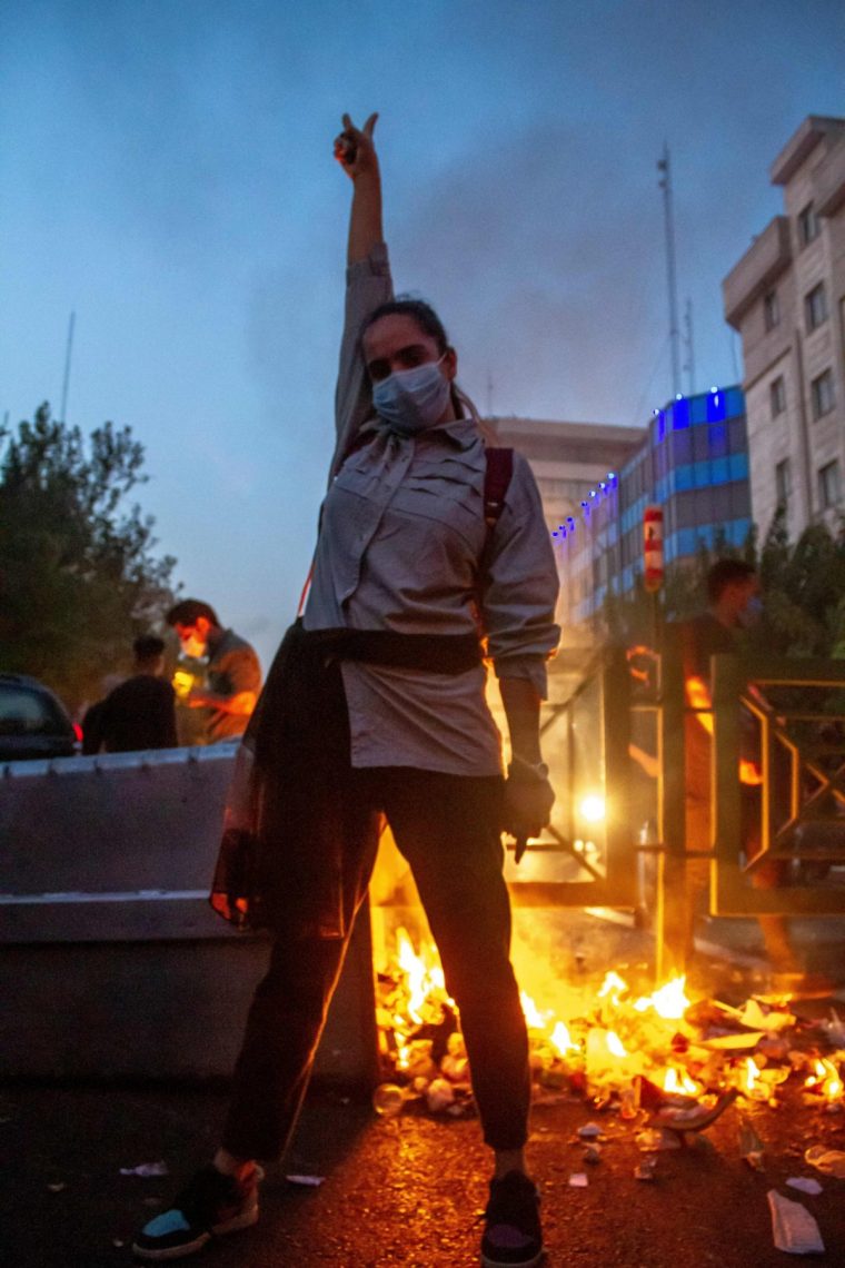 A young woman protests in Iran without wearing a hijab in 2022 (Photo: Middle East Images / AFP via Getty Images)