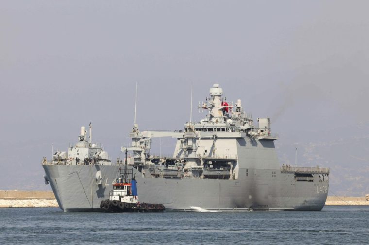 A tugboat guides a Turkish navy ship into Beirut's port as it arrives to evacuate Turkish nationals from war-torn Lebanon on October 9, 2024. Several countries have launched operations to get nationals out of Lebanon since Israel launched ground raids into its neighbour and Iran fired missiles at Israel. (Photo by Anwar AMRO / AFP) (Photo by ANWAR AMRO/AFP via Getty Images)