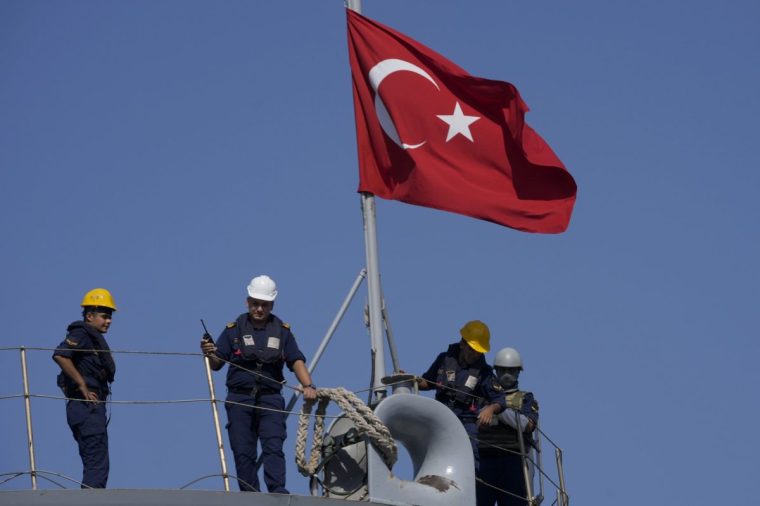 Turkish navy soldiers stand on their vessel, which docked at the port of Beirut to unload human aid and to evacuate their citizens, in Beirut, Lebanon, Wednesday, Oct. 9, 2024. (AP Photo/Hussein Malla)