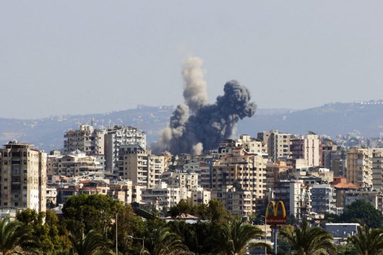 A smoke cloud erupts following an Israeli air strike on a village near Lebanon's southern city of Tyre on October 9, 2024. Israel expanded operations in Lebanon nearly a year after Hezbollah began exchanging fire in support of its ally, Hamas, following the Palestinian group's deadly attack on Israel on October 7, 2023. (Photo by KAWNAT HAJU / AFP) (Photo by KAWNAT HAJU/AFP via Getty Images)