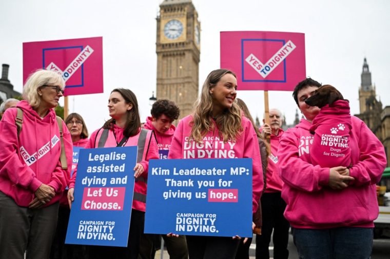 Campaigners from Dignity in Dying demonstrate at Westminster during a parliamentary debate on the proposal to legalise euthanasia in the UK their own terms. Lawmakers in the House of Commons will get a free vote on Labour MP Kim Leadbeater's Terminally Ill Adults (End of Life) Bill, allowing them to vote with their conscience rather than along party political lines. (Photo by JUSTIN TALLIS / AFP) (Photo by JUSTIN TALLIS/AFP via Getty Images)