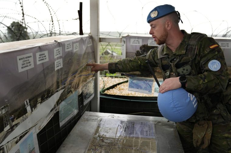 FILE - Capt. Hector Alonso Garcia of the Spanish UNIFIL battalion, the United Nations peacekeeping force in south Lebanon, shows on a map the blue line, a U.N.-drawn boundary between Lebanon and Israel, at an observation tower in Abbassiyeh, a Lebanese border village with Israel, on Wednesday, Jan. 10, 2024. (AP Photo/Hussein Malla, File)