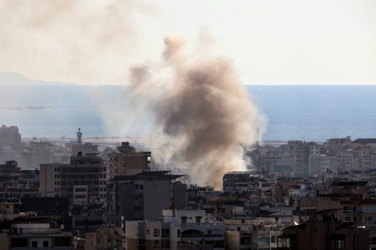 Thick smoke billows over buildings following an Israeli airstrike on Beirut's southern suburbs on October 19, 2024, amid the ongoing war between Israel and Hezbollah. (Photo by ANWAR AMRO / AFP) (Photo by ANWAR AMRO/AFP via Getty Images)