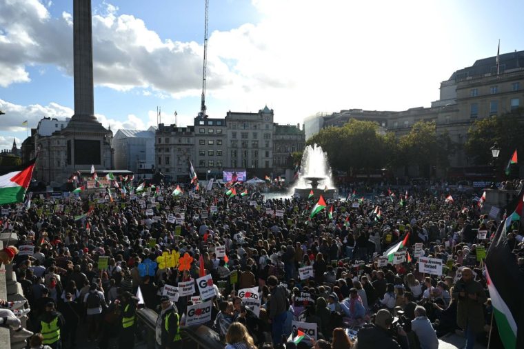 LONDON, UNITED KINGDOM - OCTOBER 19: Protesters holding Palestinian and Lebanese flags, gathering at Trafalgar Square stage a solidarity demonstration demanding a ceasefire in Gaza and Lebanon under continuous Israeli attacks on October 19, 2024, in London, United Kingdom. (Photo by Rasid Necati Aslim/Anadolu via Getty Images)