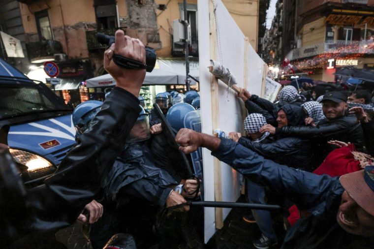 Demonstrators and police clash during a protest to express support for Palestinians in Gaza, during the G7 defense meeting in Naples, Italy, Saturday, Oct. 19, 2024. (Alessandro Garofalo/LaPresse via AP)