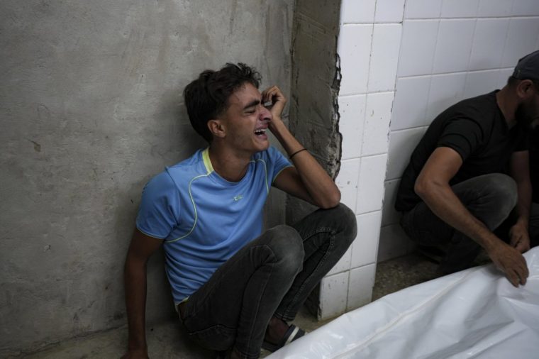 A young Palestinian mourns his relatives killed in the Israeli bombardment of the Gaza Strip at a hospital in Deir el-Balah, Sunday, Oct. 20, 2024. (AP Photo/Abdel Kareem Hana)