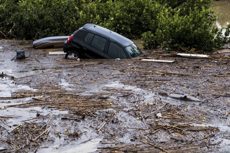 Cars are being swept away by the water, after floods preceded by heavy rains caused the river to overflow its banks in the town of Alora, Malaga, Tuesday, Oct. 29, 2024. (AP Photo/Gregorio Marrero)