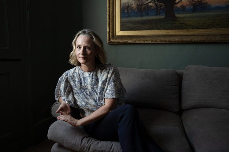 Christina Hopkinson at home in London with a book she made about her Mother. 25/6/24. Photo Tom Pilston