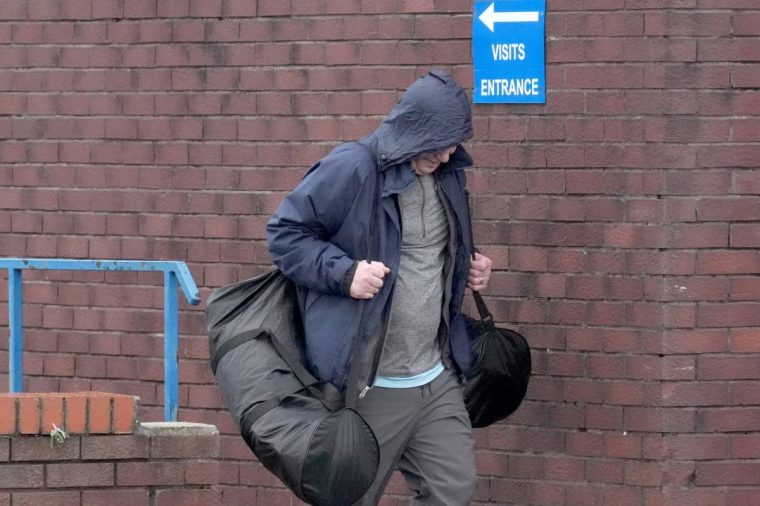 LIVERPOOL, UNITED KINGDOM - OCTOBER 22: A person leaves HM Prison Liverpool on October 22, 2024 in Liverpool, United Kingdom. The Labour government in the UK has implemented an early prisoner release scheme, in order to cope with the overcrowding of prisons in England and Wales. On Tuesday, 1,100 inmates are due to be released after serving 40% of their sentences. In September, 1,700 prisoners were set free under the scheme, which was drawn up by the previous government. (Photo by Christopher Furlong/Getty Images)