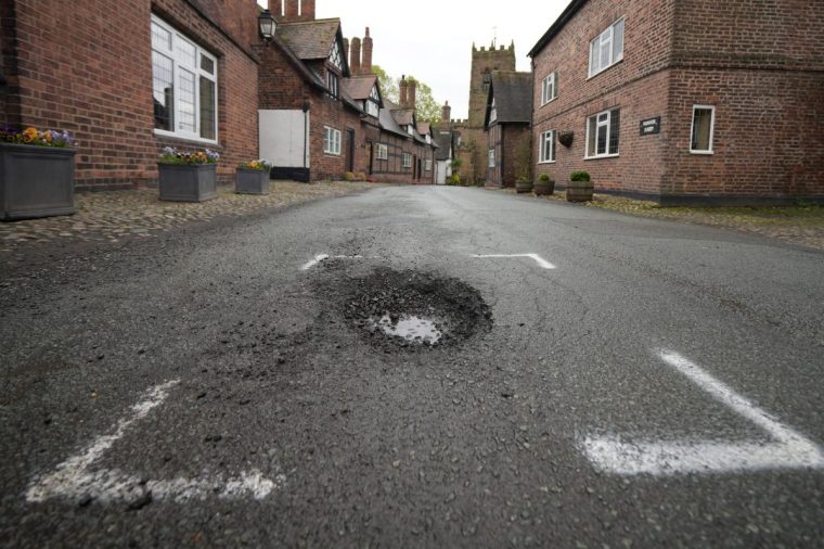 NORTHWICH, UNITED KINGDOM- APRIL 25: A pothole is marked up for repair in the historic village of Great Budworth on April 25, 2024 near Northwich, United Kingdom. The UK's roads have a large number of potholes due to high traffic levels and its cold and wet climate during winter. British motoring organisation, the RAC, says new figures show vehicle breakdowns rose by 9% in the last year due to potholes. (Photo by Christopher Furlong/Getty Images)