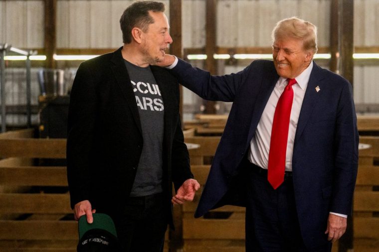 Elon Musk, chief executive officer of Tesla Inc., left, and former US President Donald Trump, prior to a campaign event at the Butler Farm Show in Butler, Pennsylvania, US, on Saturday, Oct. 5, 2024. Republican nominee??Donald Trump??rallied supporters at the site of a July assassination attempt, returning to the Pennsylvania venue where a gunman's bullet bloodied his ear and upended the presidential campaign. Photographer: Justin Merriman/Bloomberg via Getty Images