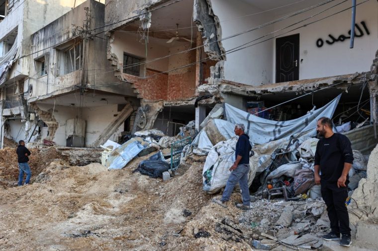 People inspect the damage following an Israeli raid on the Nur Shams camp for Palestinian refugees, near Tulkarem in the north of the occupied West Bank on October 31, 2024. Four Palestinians were killed in Israeli military operations in the occupied West Bank city of Tulkarem overnight, the Palestinian health ministry and an official said on Octtober 31. (Photo by Zain JAAFAR / AFP) (Photo by ZAIN JAAFAR/AFP via Getty Images)