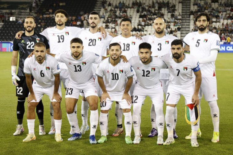 (Top L to R) Palestine's goalkeeper #22 Rami Hamadeh, Palestine's midfielder #19 Wessam Abou Ali, Palestine's forward #20 Ameed Mahajna, Palestine's midfielder #18 Jonathan Cantillana, Palestine's midfielder #03 Mohammed Rashid, Palestine's defender #05 Mohammed Saleh, (bottom L to R) Palestine's midfielder #06 Oday Kharoub, Palestine's forward #13 Omar Faraj, Palestine's midfielder #10 Mahmoud Abu Warda, Palestine's defender #12 Camilo Saldana and Palestine's defender #07 Musab Al-Battat pose for a team picture ahead of the 2026 FIFA World Cup AFC qualifiers group B football match between Palestine and Kuwait at the Jassim bin Hamad Stadium in Doha on October 15, 2024. (Photo by KARIM JAAFAR / AFP) (Photo by KARIM JAAFAR/AFP via Getty Images)