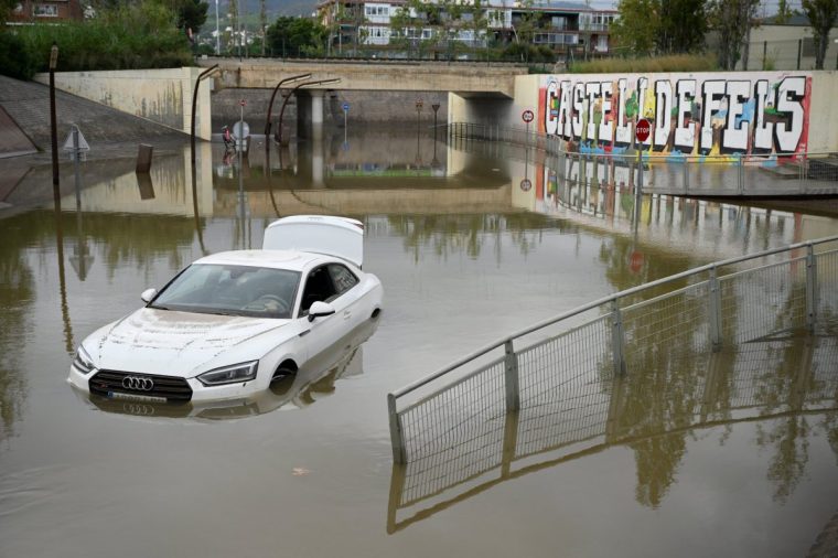 TOPSHOT - A flooded car is pictured in the Barcelona suburbs of Castelldefels on November 4, 2024 as torrential rain struck Catalonia. Spain dreads more flood deaths as rain pounds Catalonia, where residents received telephone alerts urging the utmost caution, following deadly flooding that left 217 dead, almost all in the eastern Valencia region. (Photo by Josep LAGO / AFP) (Photo by JOSEP LAGO/AFP via Getty Images)