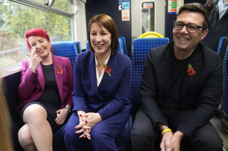 EMBARGOED TO 1300 THURSDAY NOVEMBER 7 Chancellor of the Exchequer Rachel Reeves (centre) with Transport Secretary Louise Haigh and the Mayor of Greater Manchester Andy Burnham travelling to Stalybridge station by electric train following the announcement in the Budget securing funding for the Transpennine Route Upgrade and A57 upgrade project. Picture date: Thursday November 7, 2024. PA Photo. See PA story TRANSPORT North. Photo credit should read: Danny Lawson/PA Wire