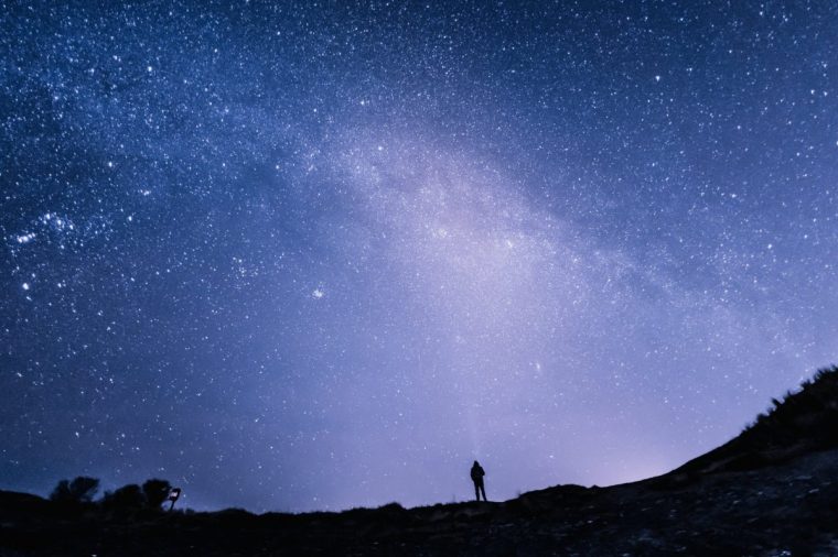 Senior Caucasian man profile and silhouette against starry sky background